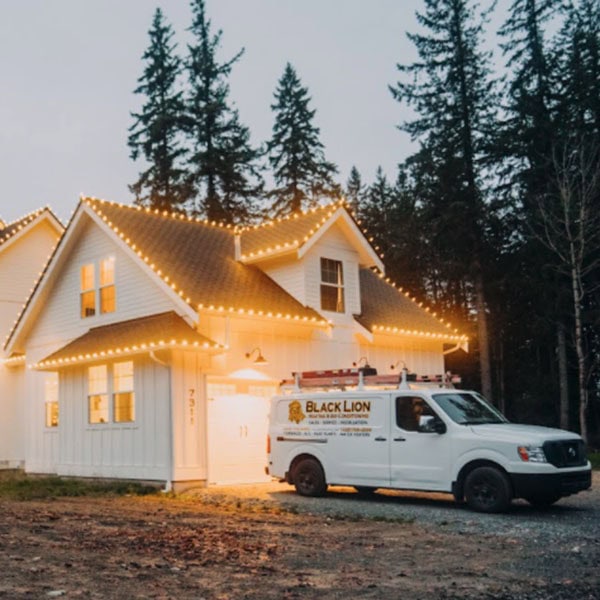 Home lit up with outdoor lighting installed by Black Lion Heating, Air Conditioning, and Electrical.
