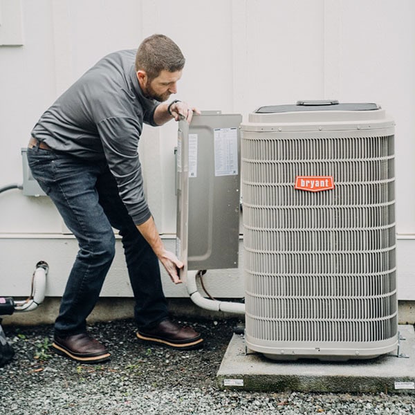 air-conditioning-1_600x600 Black Lion Heating, Air Conditioning, & Electrical technician installing a Bryant air conditioner.