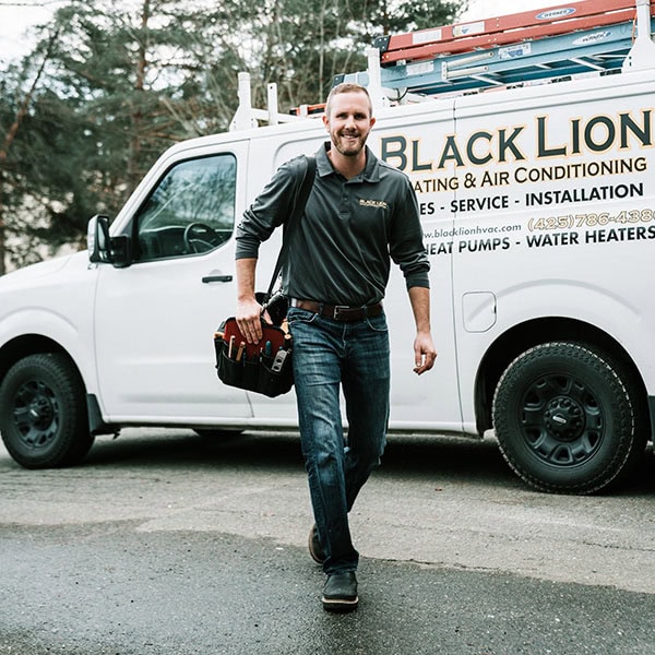 air-conditioning-maintenance-1_600x600 Black Lion Heating, Air Conditioning, & Electrical technician walking away from the company truck holding a tool bag.