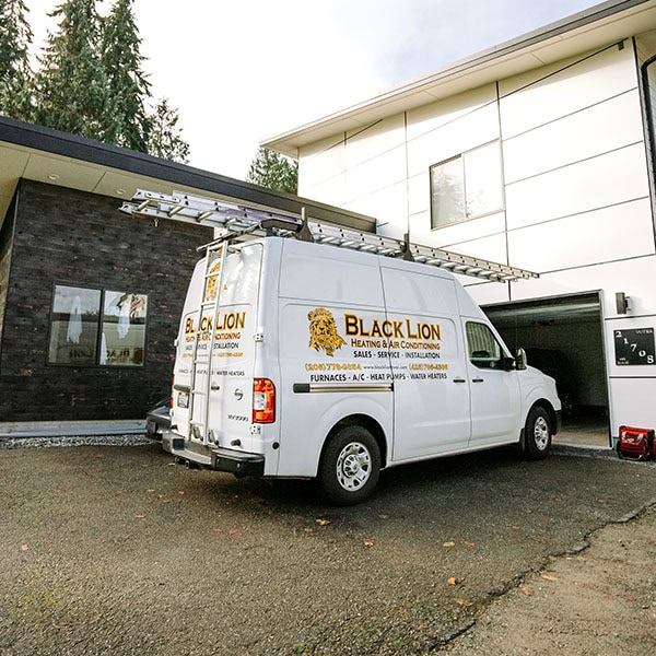 Black Lion Heating, Air Conditioning, & Electrical company truck in front of a home.