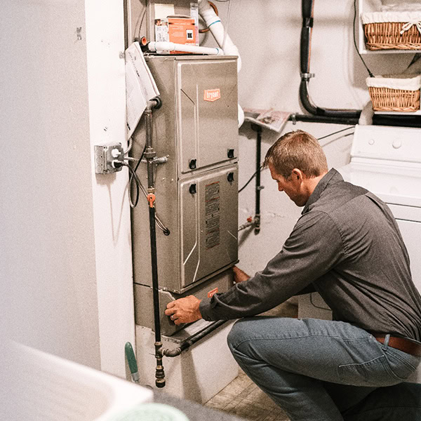 Black Lion Heating, Air Conditioning, & Electrical technician installing a Bryant gas furnace.