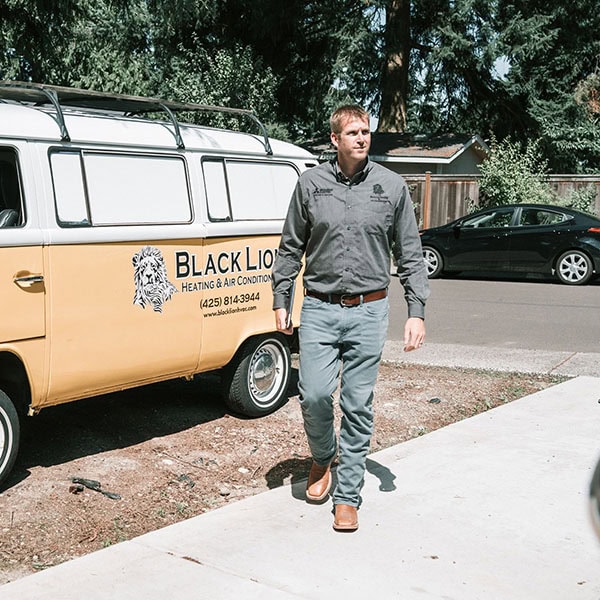 heat-pump-installation-1_600x600 Black Lion Heating, Air Conditioning, & Electrical technician walking in front of company truck.