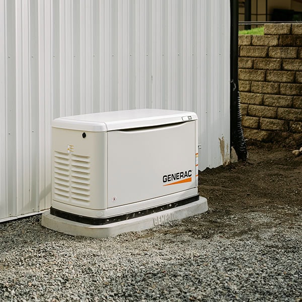 Generac whole-house generator next to a house.